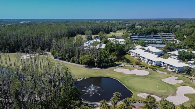 bird's eye view featuring a forest view, view of golf course, and a water view