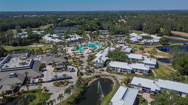 birds eye view of property with a water view, a forest view, and view of golf course