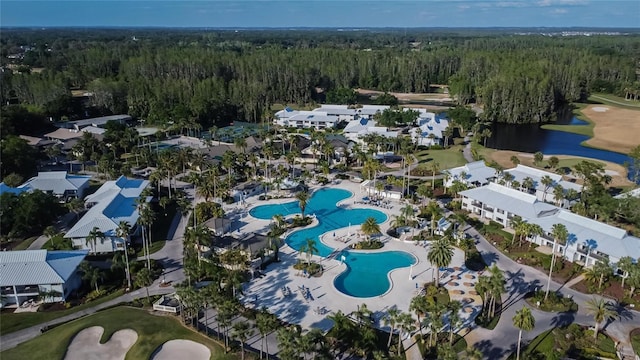 aerial view with a wooded view and a water view