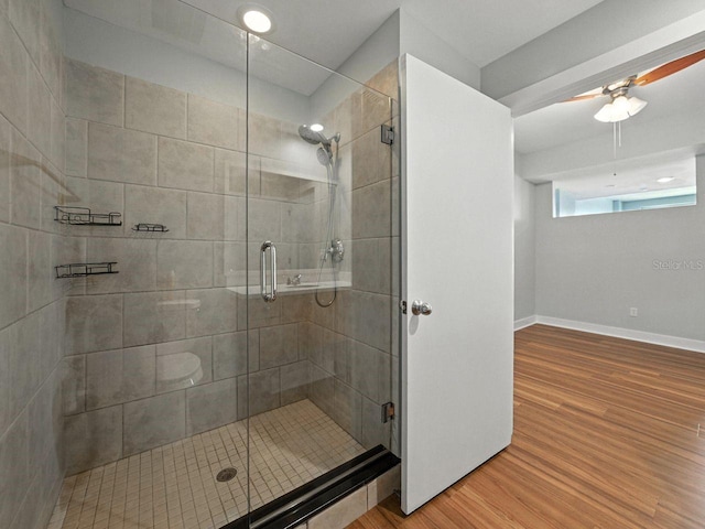 1208 E Kennedy Blvd Unit 1125, Tampa, FL 33602 - full bathroom featuring wood finished floors, a shower stall, and a ceiling fan