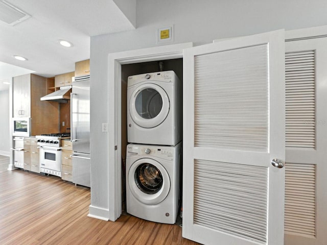 1208 E Kennedy Blvd Unit 1125, Tampa, FL 33602 - laundry room featuring estacked washer and dryer, light wood-style flooring, and recessed lighting