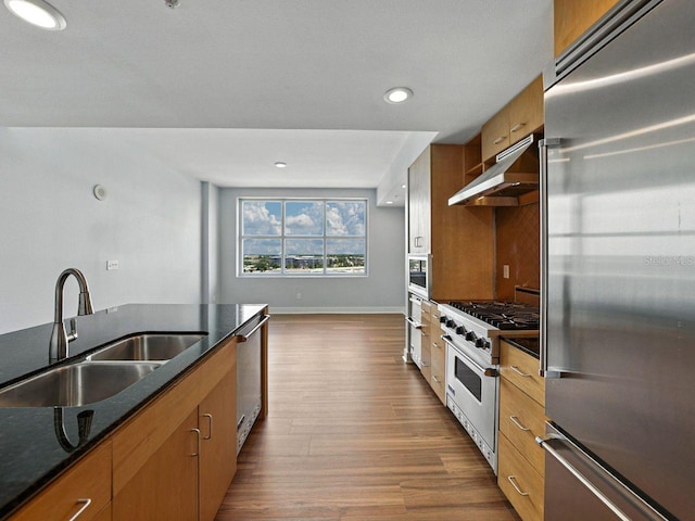 1208 E Kennedy Blvd Unit 1125, Tampa, FL 33602 - kitchen with premium appliances, ventilation hood, dark wood finished floors, brown cabinets, and dark stone countertops