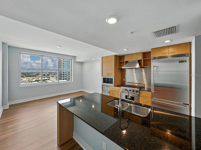 1208 E Kennedy Blvd Unit 1125, Tampa, FL 33602 - kitchen with built in appliances, open shelves, under cabinet range hood, wood finished floors, and decorative backsplash
