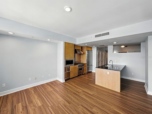 1208 E Kennedy Blvd Unit 1125, Tampa, FL 33602 - kitchen featuring premium appliances, dark wood-style flooring, dark countertops, under cabinet range hood, and brown cabinetry