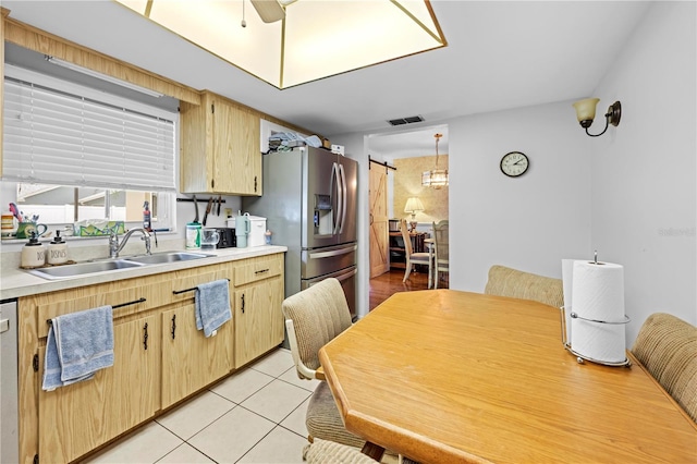 kitchen featuring visible vents, a sink, light brown cabinets, and light countertops