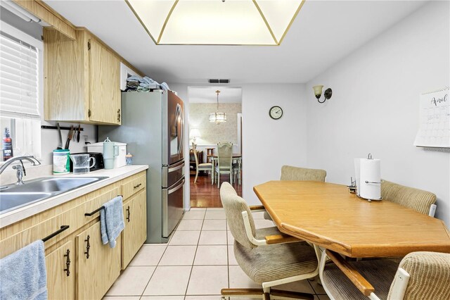 kitchen featuring light countertops, light brown cabinetry, light tile patterned flooring, and visible vents