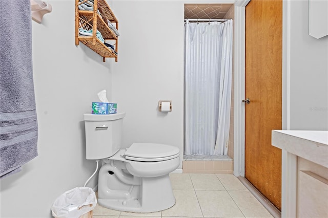 full bath with toilet, a shower stall, and tile patterned flooring