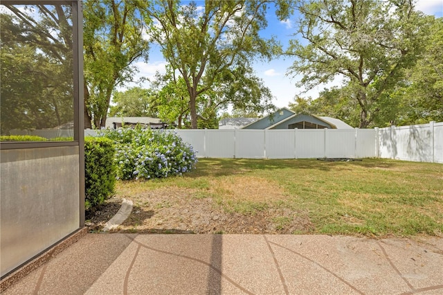view of yard featuring a patio and a fenced backyard
