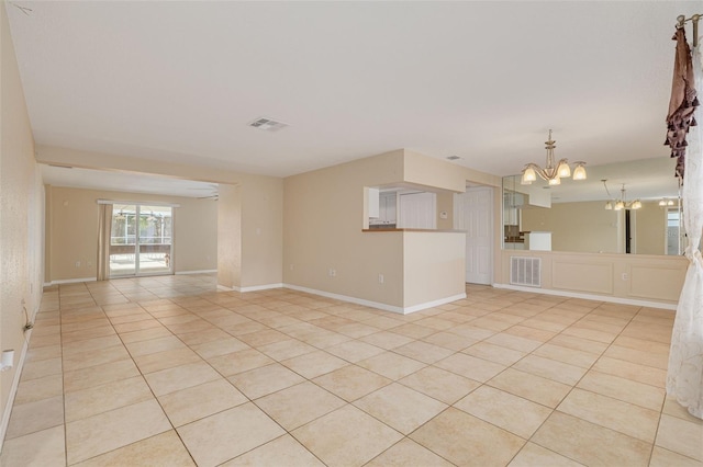 empty room featuring visible vents, a chandelier, and light tile patterned floors