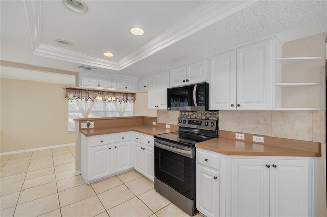 kitchen with a tray ceiling, white cabinets, stainless steel electric stove, and a peninsula