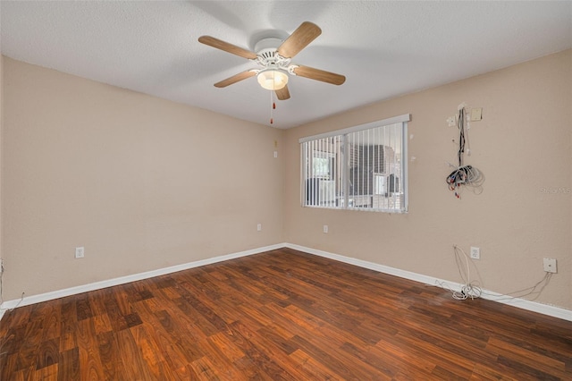 empty room with wood finished floors, ceiling fan, and baseboards