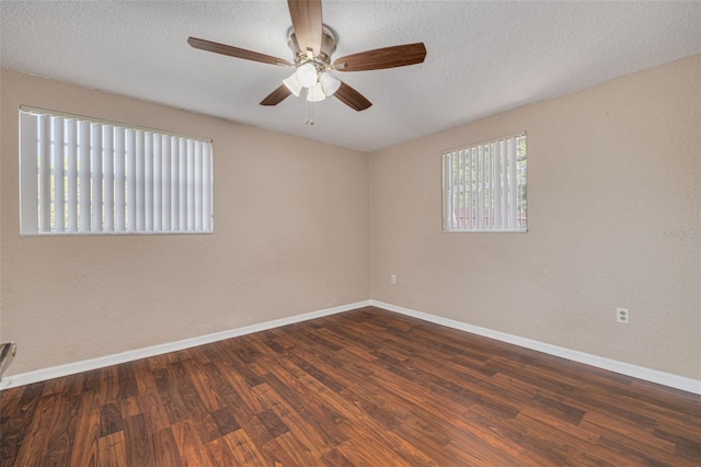 empty room with baseboards, ceiling fan, wood finished floors, and a textured ceiling
