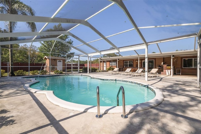 view of swimming pool featuring a fenced in pool, a patio area, a storage shed, an outbuilding, and fence
