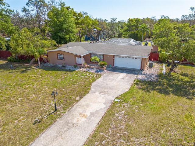 ranch-style home featuring concrete driveway, stucco siding, a front yard, a garage, and fence