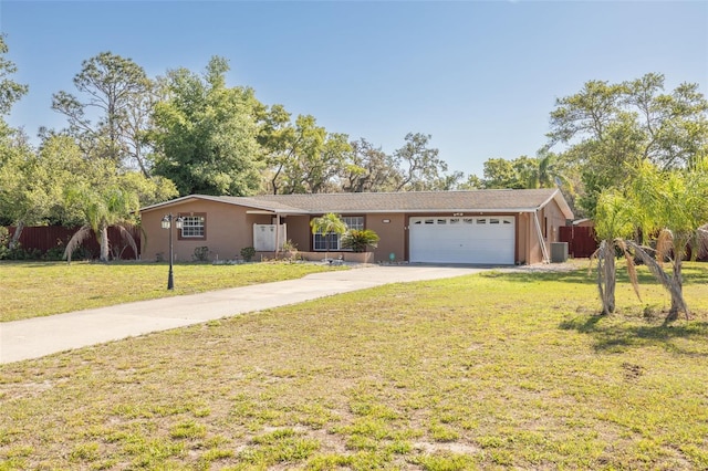 ranch-style home with an attached garage, fence, driveway, and a front lawn