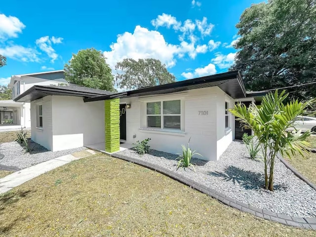 7101 N 9th St, Tampa, FL 33604 - view of front of house featuring stucco siding