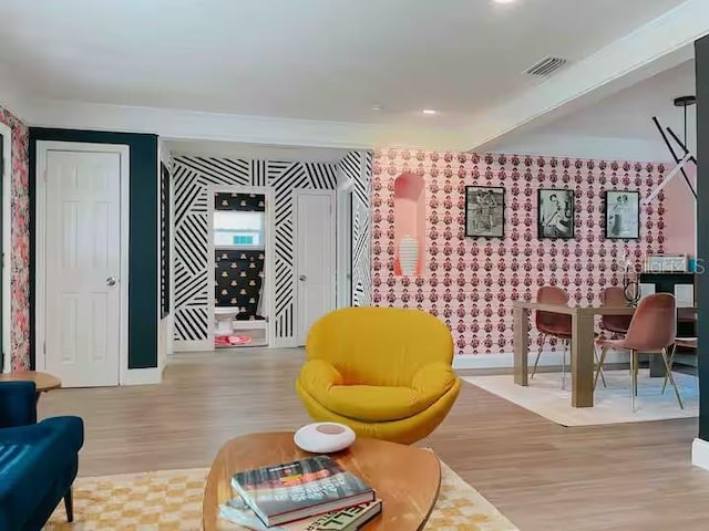 7101 N 9th St, Tampa, FL 33604 - living area featuring wallpapered walls, wood finished floors, baseboards, and an accent wall