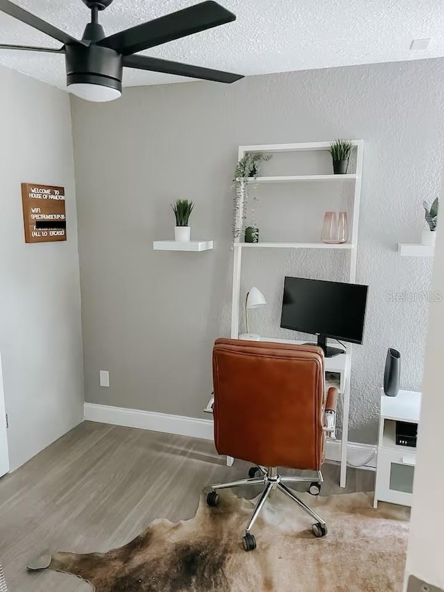 7101 N 9th St, Tampa, FL 33604 - office area featuring wood finished floors, ceiling fan, baseboards, and a textured ceiling