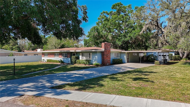 13116 N Oregon Ave, Tampa, FL 33612 - ranch-style home featuring concrete driveway, a chimney, a carport, fence, and a front yard