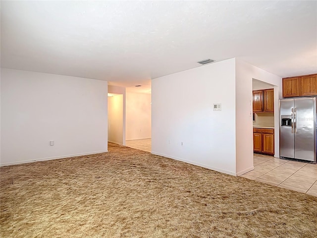 13116 N Oregon Ave, Tampa, FL 33612 - unfurnished living room featuring visible vents, baseboards, and light carpet