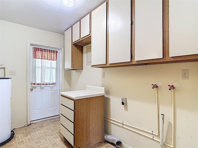13116 N Oregon Ave, Tampa, FL 33612 - laundry area featuring water heater, baseboards, and cabinet space