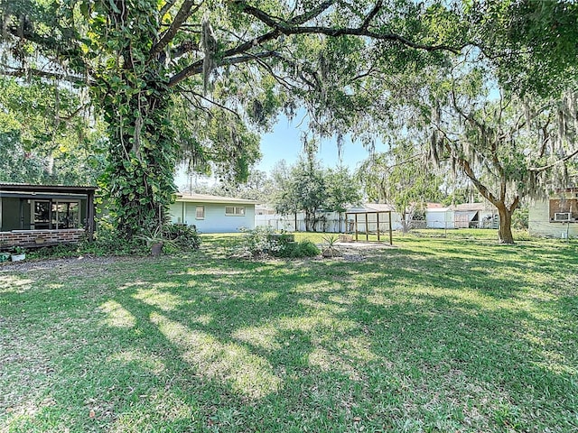 13116 N Oregon Ave, Tampa, FL 33612 - view of yard with an outdoor structure, a greenhouse, and fence