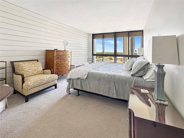 bedroom featuring expansive windows and carpet