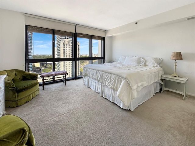 bedroom with visible vents and carpet flooring