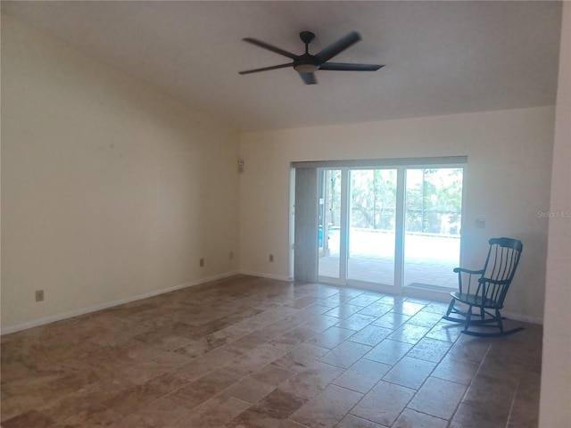 empty room with vaulted ceiling, a ceiling fan, and baseboards
