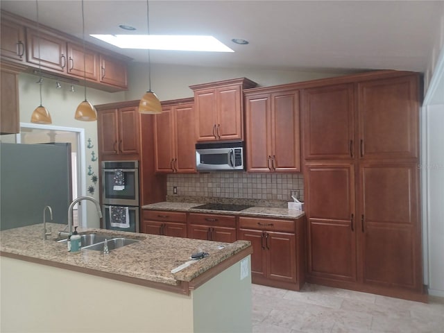 kitchen with stainless steel appliances, a sink, vaulted ceiling, backsplash, and light stone countertops