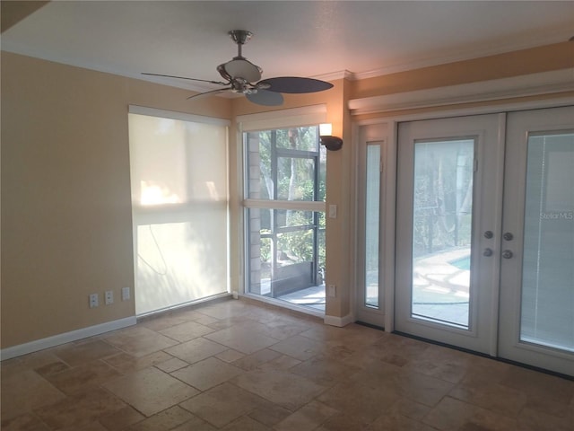 doorway to outside with stone tile floors, a ceiling fan, french doors, crown molding, and baseboards