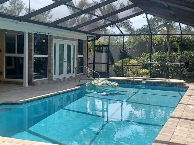 outdoor pool with a patio, a lanai, french doors, and an in ground hot tub