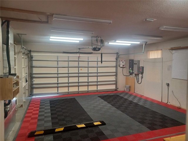 garage featuring electric panel and a garage door opener