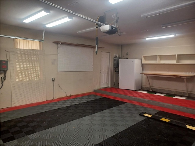 garage with water heater, a garage door opener, and freestanding refrigerator