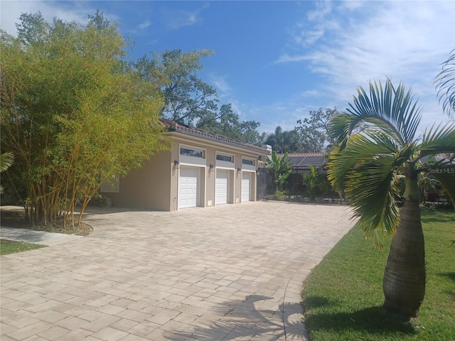 garage featuring decorative driveway