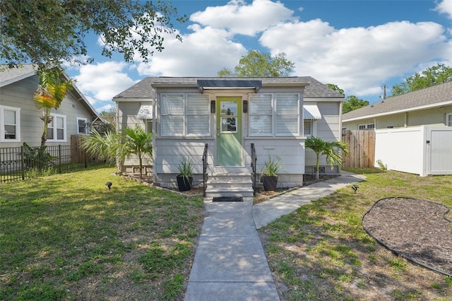 3611 4th Ave N, Saint Petersburg, FL 33713 - bungalow-style home with entry steps, a fenced backyard, a front lawn, and a gate