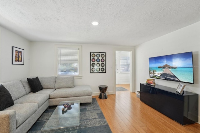 3611 4th Ave N, Saint Petersburg, FL 33713 - living area with recessed lighting, light wood-style flooring, a textured ceiling, and baseboards