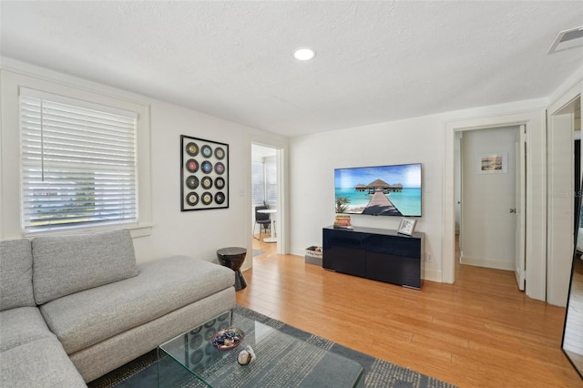 3611 4th Ave N, Saint Petersburg, FL 33713 - living room featuring recessed lighting, light wood finished floors, visible vents, and a textured ceiling