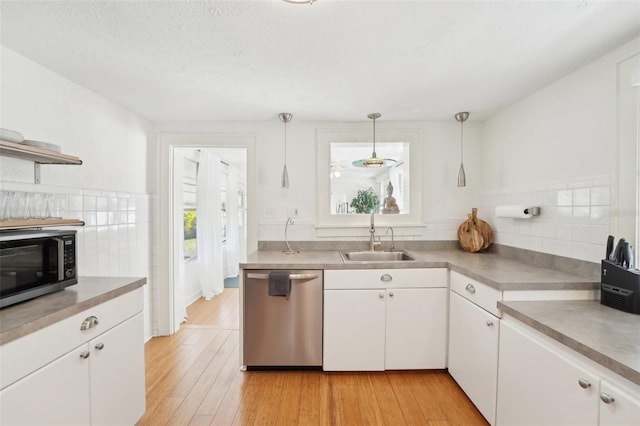 3611 4th Ave N, Saint Petersburg, FL 33713 - kitchen featuring white cabinets, a sink, backsplash, and appliances with stainless steel finishes