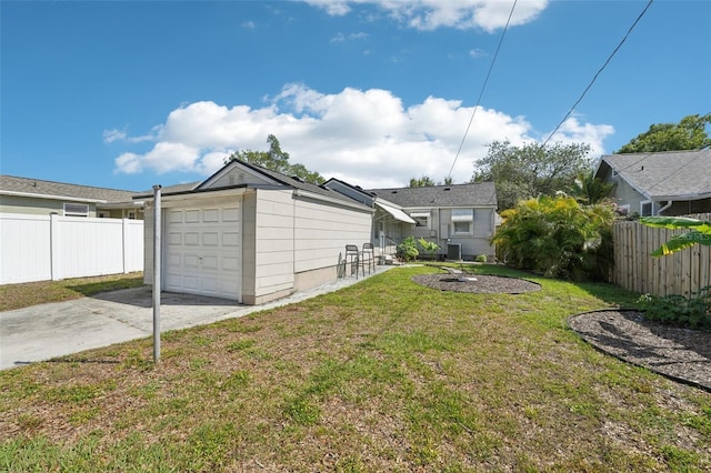 3611 4th Ave N, Saint Petersburg, FL 33713 - view of yard with an attached garage, a fire pit, concrete driveway, and fence
