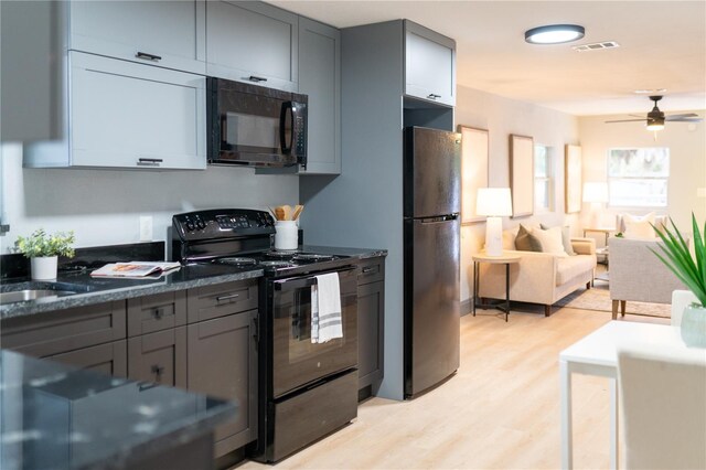 kitchen featuring gray cabinets, light wood-type flooring, black appliances, and a ceiling fan