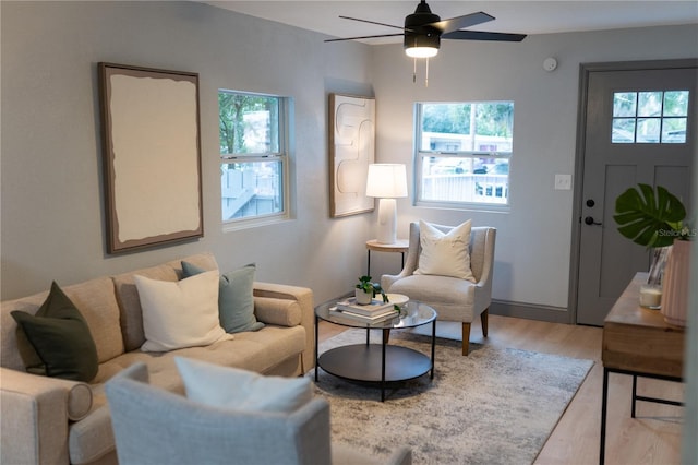 living area featuring a ceiling fan and wood finished floors