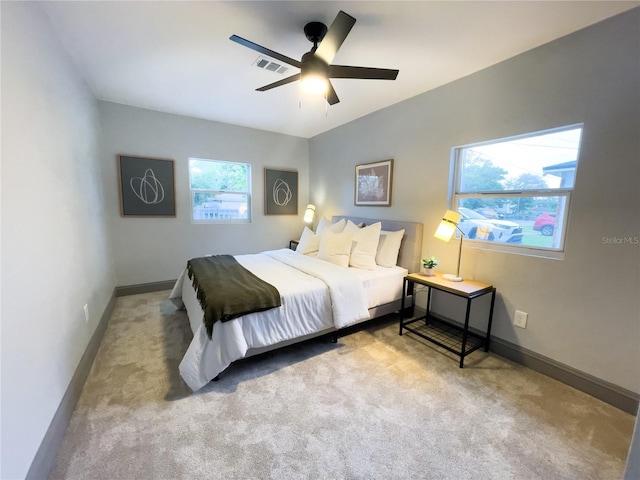 bedroom with a ceiling fan, baseboards, carpet, and visible vents