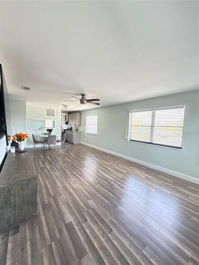 5973 Terrace Park Dr N Unit 311, Saint Petersburg, FL 33709 - unfurnished living room featuring ceiling fan, baseboards, dark wood-style floors, and visible vents
