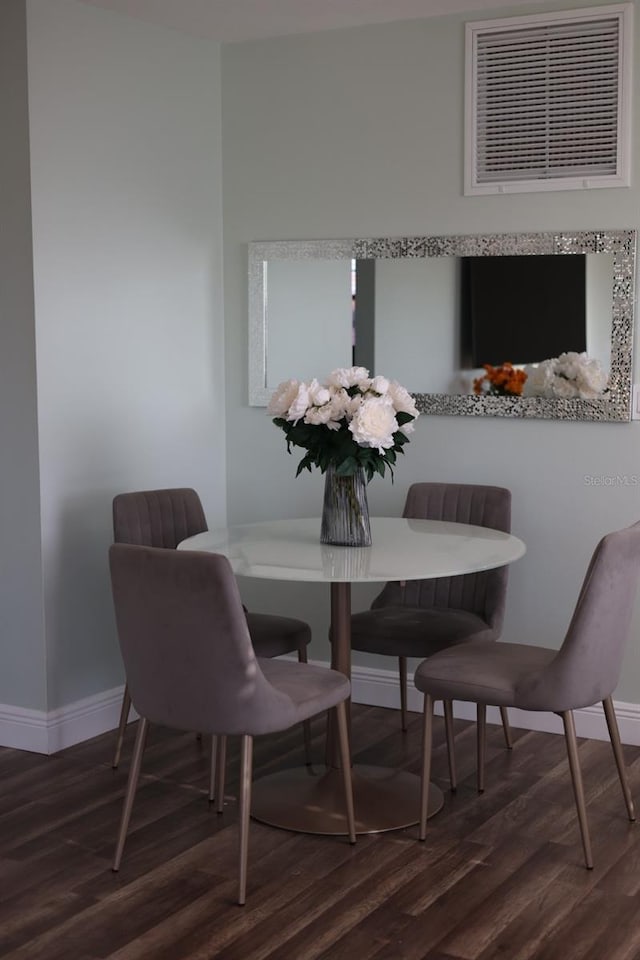 5973 Terrace Park Dr N Unit 311, Saint Petersburg, FL 33709 - dining room with visible vents, baseboards, and wood finished floors