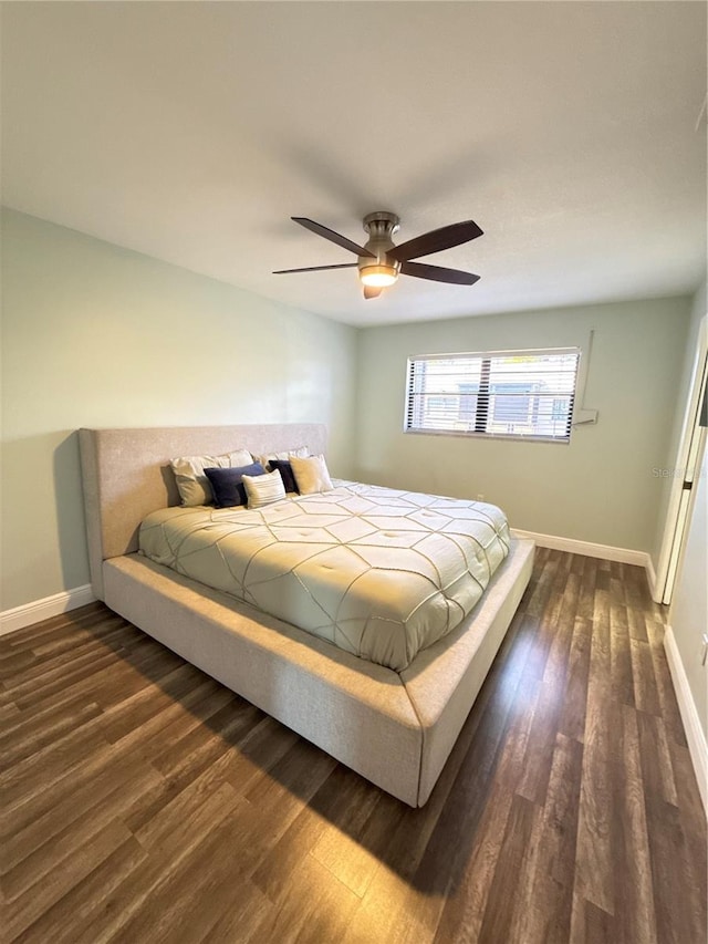 5973 Terrace Park Dr N Unit 311, Saint Petersburg, FL 33709 - bedroom with dark wood-style flooring, baseboards, and ceiling fan