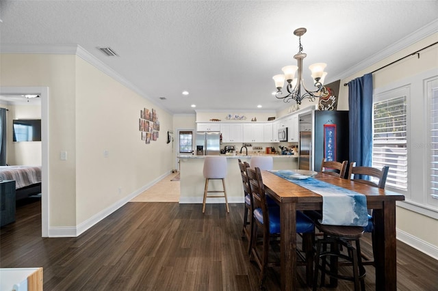 1410 25th St N, Saint Petersburg, FL 33713 - dining space featuring dark wood-style flooring, baseboards, visible vents, a notable chandelier, and ornamental molding