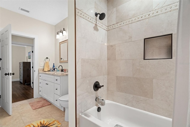 1410 25th St N, Saint Petersburg, FL 33713 - full bathroom with visible vents, toilet, vanity, and tub / shower combination