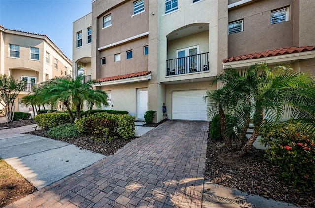805 100th Ave N, Saint Petersburg, FL 33702 - view of front of home featuring stucco siding, decorative driveway, and an attached garage