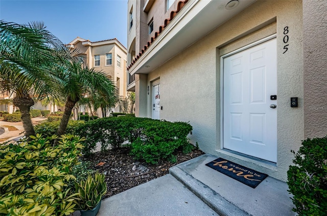 805 100th Ave N, Saint Petersburg, FL 33702 - entrance to property featuring a tiled roof and stucco siding